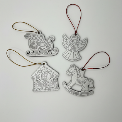 Four upright metallic silver Christmas ornaments with red and gold twine on a white background